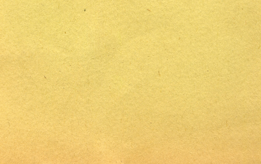 Textured paper that has yellowed with time.