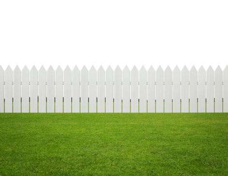 White wooden fence on the grass isolated on white background with copy space