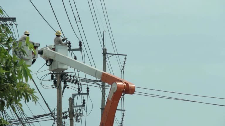 Power Line Workers on high voltage pole.