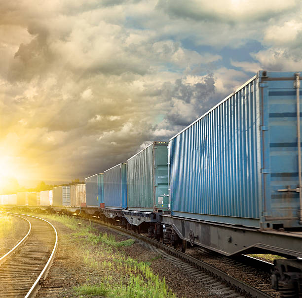 istock Old freight train moving towards beautiful sunset 451519589