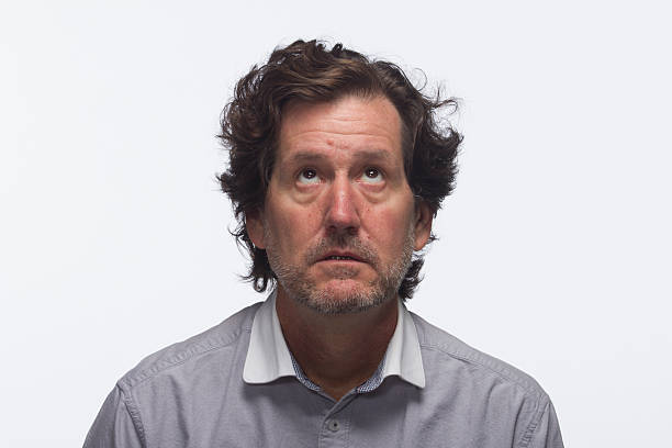 istock Annoyed man looking up in thought, horizontal 451520725
