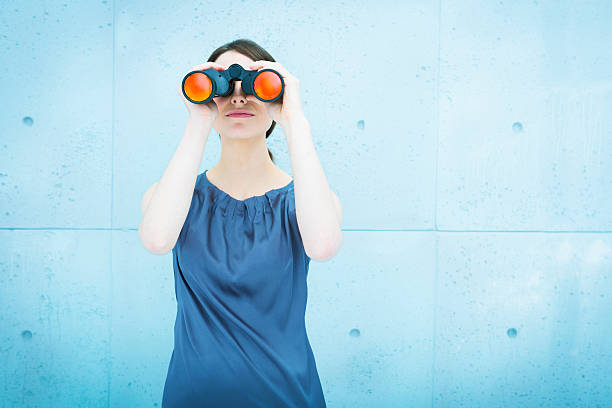 istock Businesswoman holding binoculars 451521343