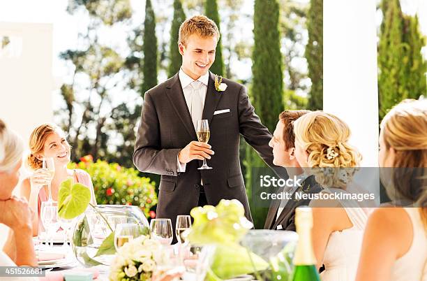 Best Man Looking At Couple While Giving Speech During Reception Stock Photo - Download Image Now