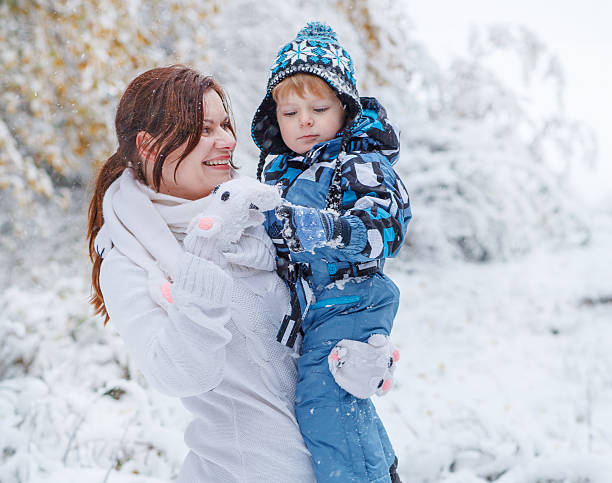 istock Mother and toddler boy having fun on winter day 451532305