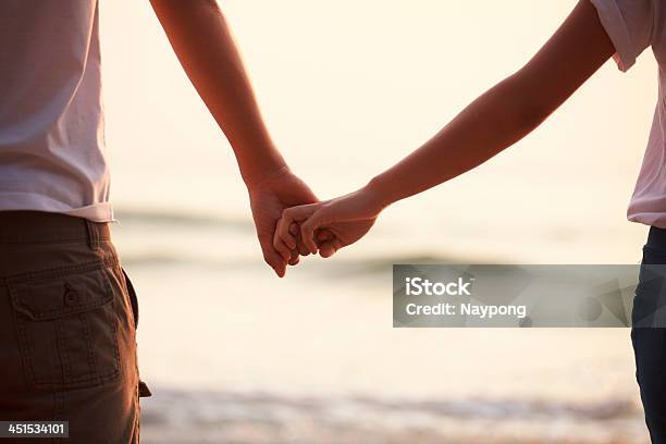 Young Couple Holding Hands Stock Photo - Download Image Now - Adult, Beach, Boyfriend