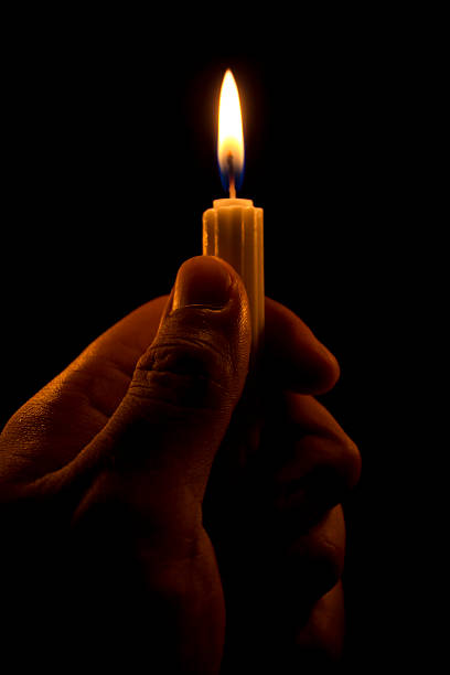 istock Hand holding candle in the dark 451537789