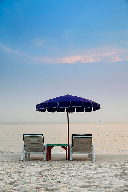 istock Tropical beach with chairs and parasol 451537889
