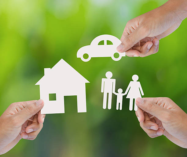 Hands holding paper house, car and family Three Caucasian hands, each holding a different image cut from paper.  The top hand is holding a car, the hand on the left is holding a house and the hand on the right is holding the image of a man and woman holding hands with a small child. Homeowners Warranty stock pictures, royalty-free photos & images
