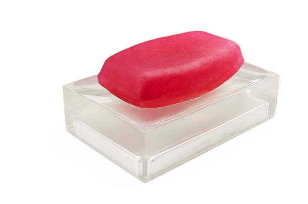 Classic red soap on a semi transparent soap-dish isolated on white