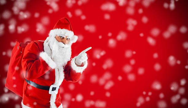 istock Santa Claus pointing in blank red with snow 451557603