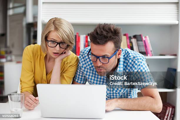 Two Surprised Students Learning In Library Stock Photo - Download Image Now - Adult, Adults Only, Bonding