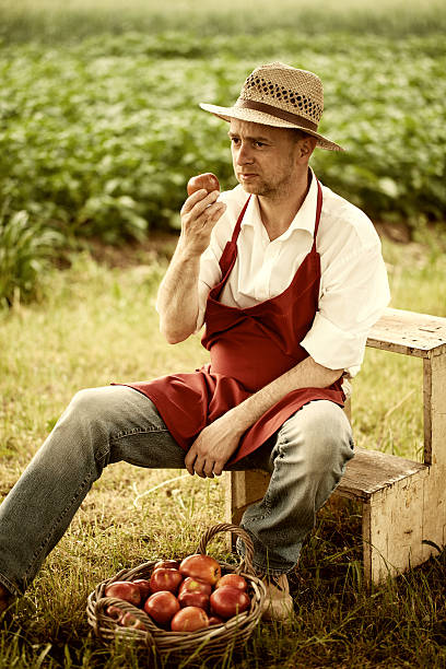 istock fruit grower in his orchard tasting apple harvest 451559271