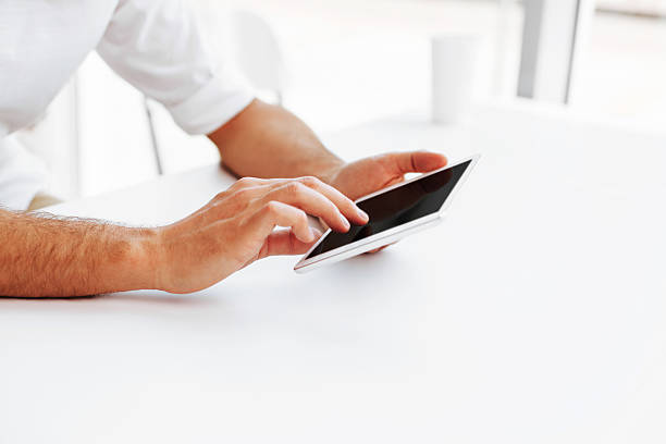 istock Man usign digital tablet at the desk 451575981