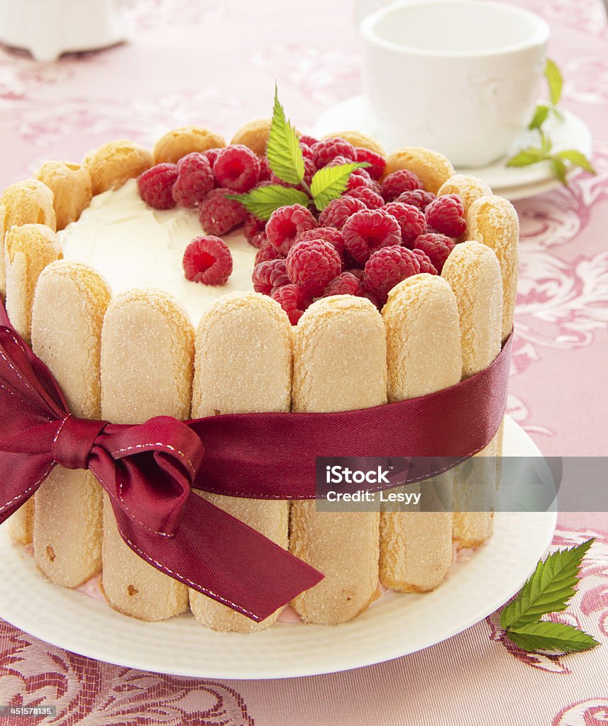 Cake "Charlotte" with raspberries and cream, selective focus. Baked Stock Photo