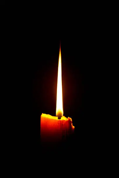Photo of Vector illustration of yellow candle on black background