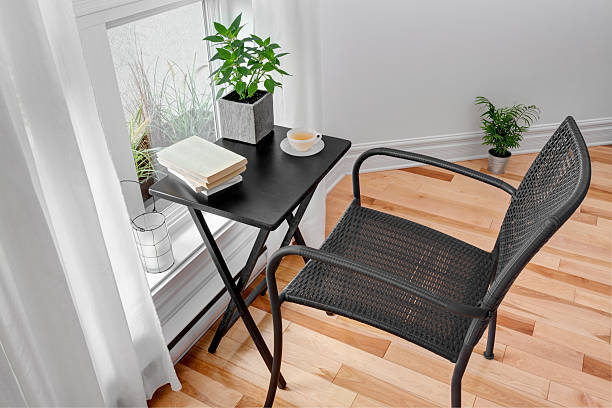 istock Chair and table in a room with green plants 451581331