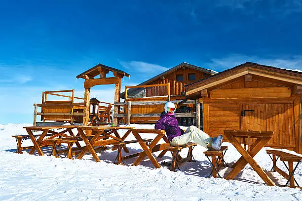 Woman at winter ski resort, Courchevel, Alps, France
