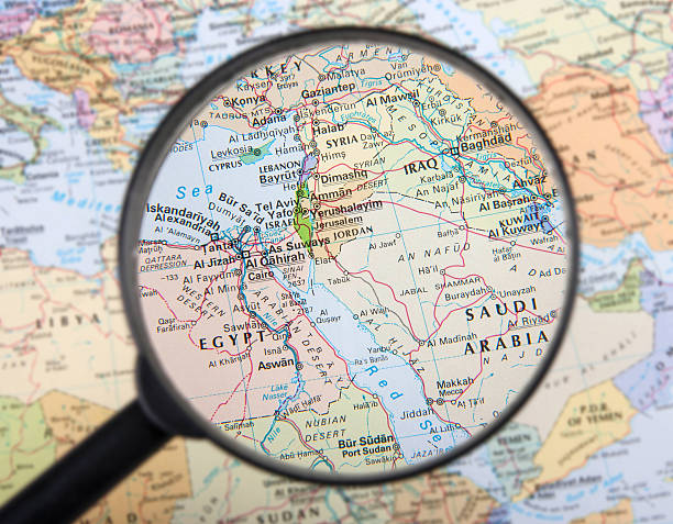 A magnifier zooming in Middle East countries on a global map Middle East under the magnifier. jordan middle east photos stock pictures, royalty-free photos & images