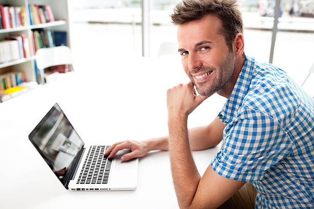 istock Handsome  happy man working with laptop 451588119