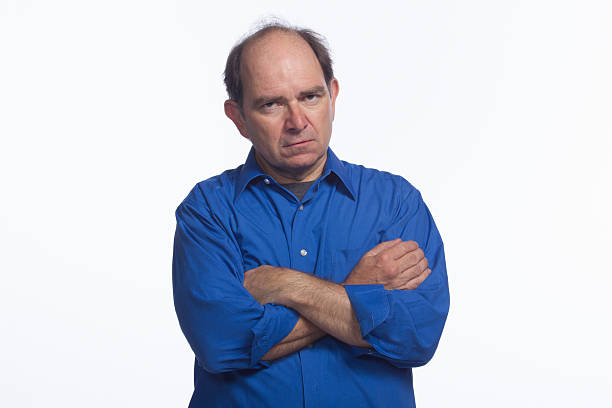 istock Man looks angry with amrs crossed, horizontal 451591151