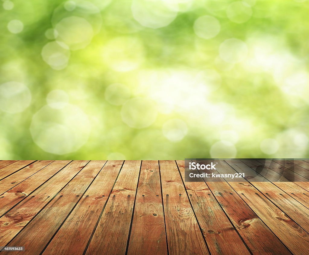 Empty wooden panel table with blurred green background Empty wooden table for product display montages Blurred Motion Stock Photo