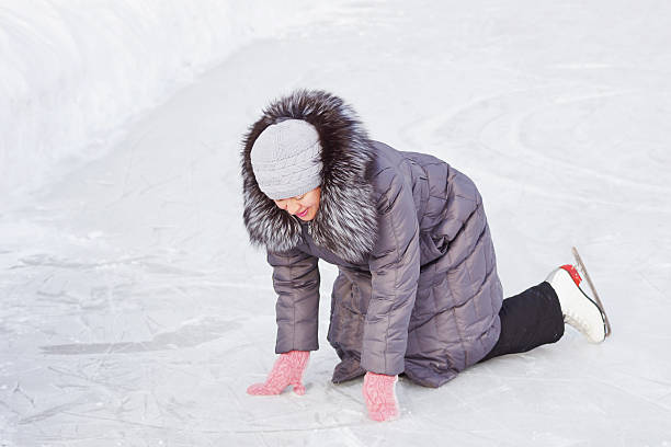 istock Woman fell on the ice rink 451597125