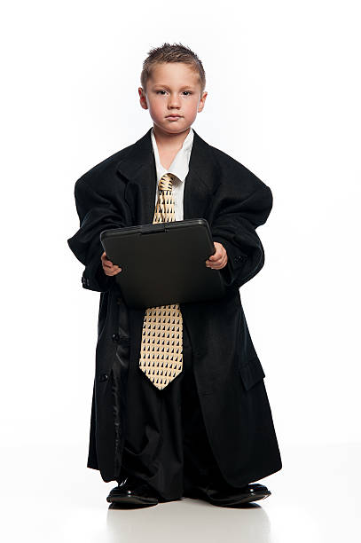 istock Little Boy Holding Clipboard Wearing Oversized Suit and Tie 451597565