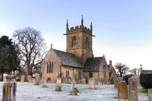 The parish church of All Saints in the small hamlet of Newton by Castle Acre in Norfolk, eastern England, with part of the graveyard. It was probably once cruciform and has been considerably altered over the centuries, although much of the church is obviously Saxon or early Norman.