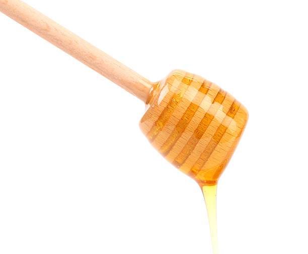istock Honey dripping from a wooden dipper 451602625