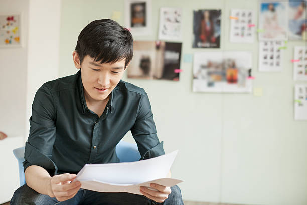 istock Professional Man Looking at Papers in Office 451603791