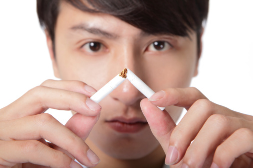 Quit smoking, man hands breaking the cigarette, close up, asian model