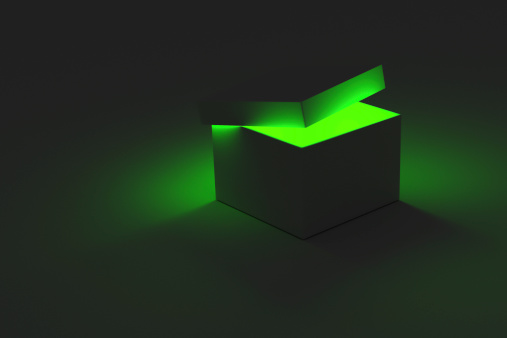 A 3D rendering of a single box with the lid partially open revealing a glowing light coming from inside.