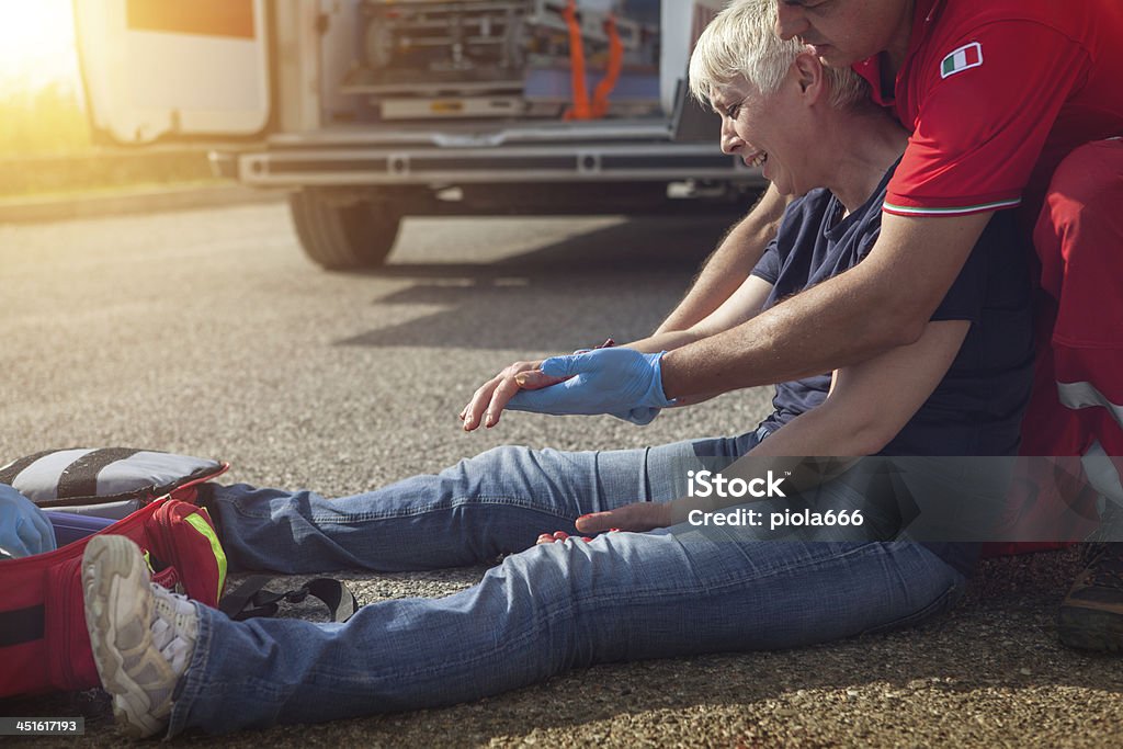 Medical emergency team arrives at street accident International Red Cross and Red Crescent Movement Stock Photo