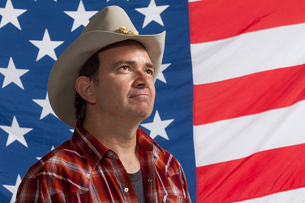 istock Cowboy in front of American flag, horizontal 451620633