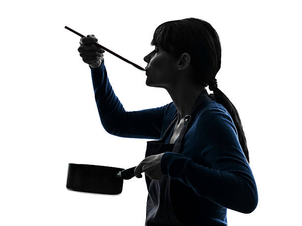 woman cooking tasting saucepan silhouette