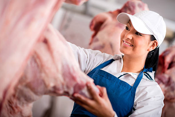 female butcher at the slaughterhouse - butcher butchers shop slaughterhouse hook 뉴스 사진 이미지