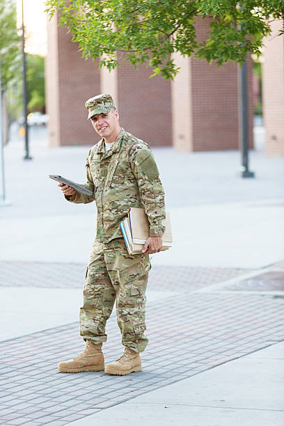 istock American Soldier with books and digital tablet 451622441