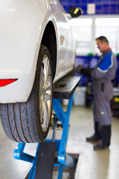 istock Auto mechanic is changin tire...prepairing car for winter 451627333