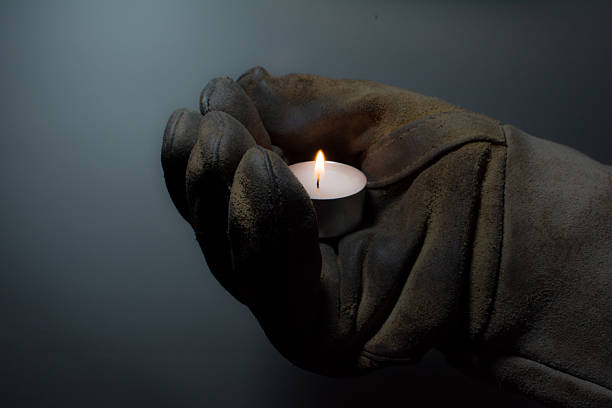 Workers hand with candle stock photo