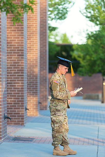 istock American Soldier with graduation hat and diploma 451630313