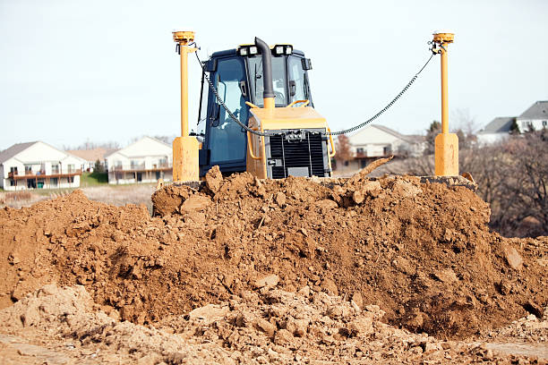istock Bulldozer Pushing Dirt with Blade Mounted GPS Receivers 451630875