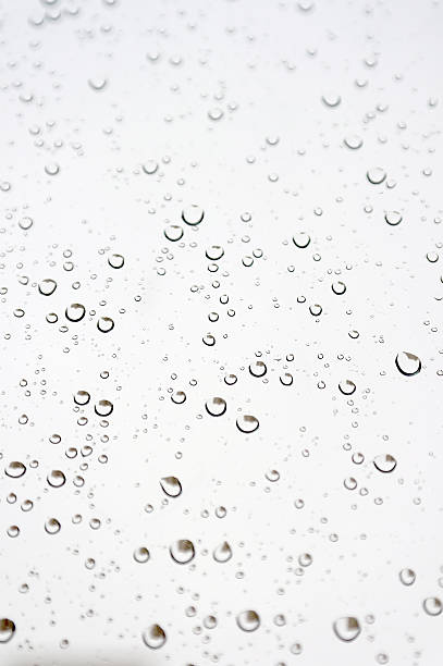 istock Drops of rain on the inclined window 451632051