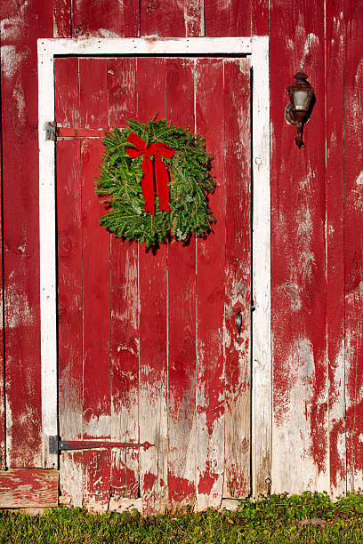 istock Red Barn Door with Christmas Wreath 451632675