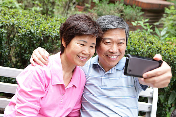 istock Happy elderly seniors couple smile using smart phone 451633035