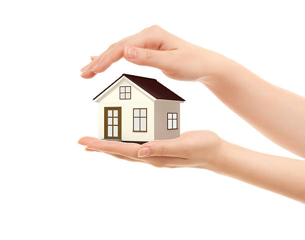 Picture of woman's hands holding a house stock photo