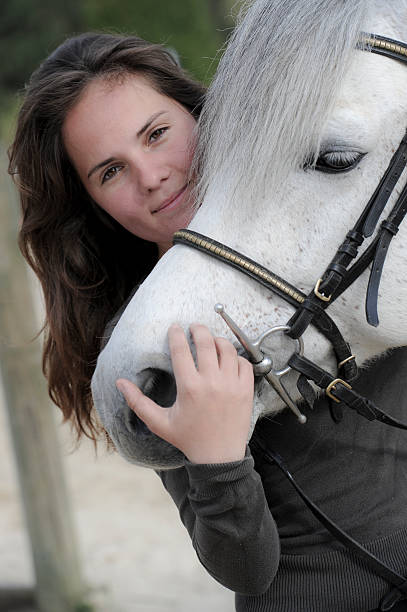 istock Woman playing with her horse 451636957