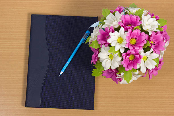 istock notebooks with bouquet of pink flowers 451637029