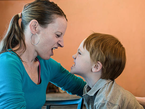 istock Mother and young son in snarling contest 451637123