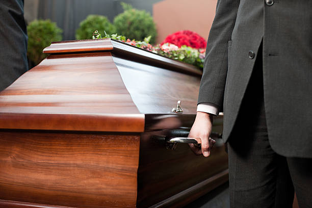 Funeral with casket carried by coffin bearer stock photo