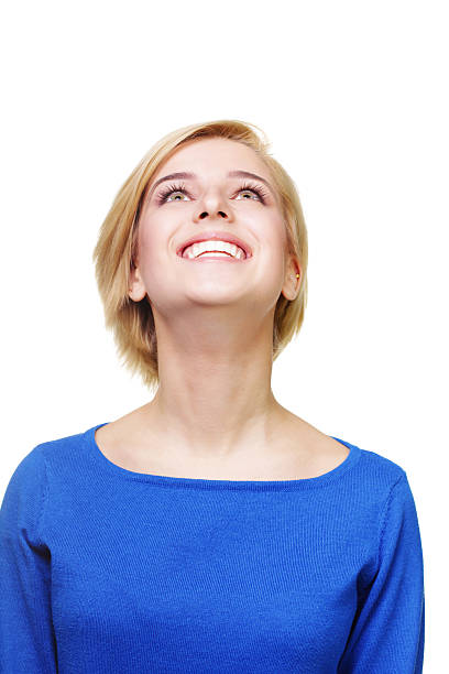 istock Young cheerful blonde woman looking up 451645385